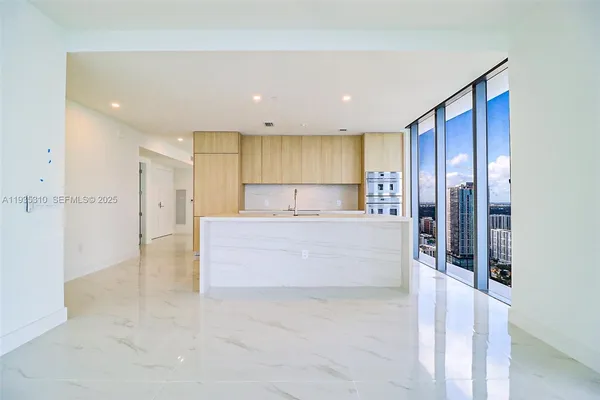 a kitchen with a sink and refrigerator