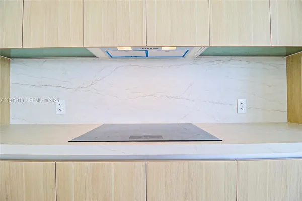 a view of a hallway with wooden floor and sliding glass door