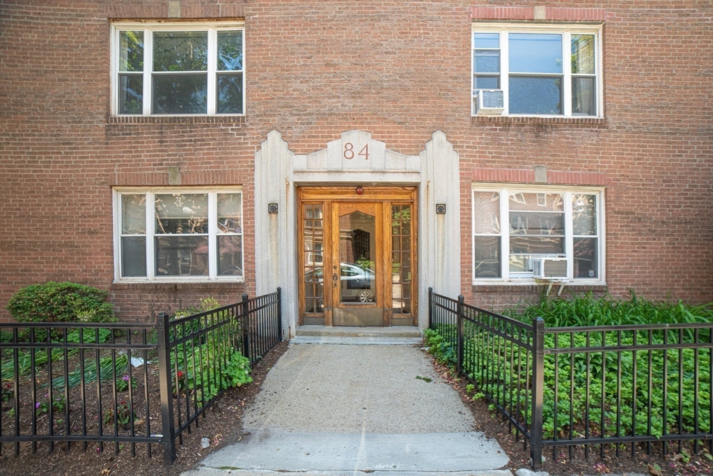 84 Strathmore Road, Unit 7 Boston, MA 02135 - Photo 1 of 17 front view of a brick house with a large windows