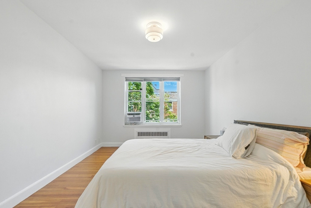 84 Strathmore Road, Unit 7 Boston, MA 02135 - Photo 11 of 17 a bedroom with a bed and a window