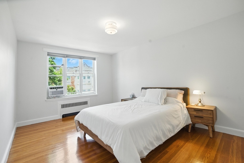84 Strathmore Road, Unit 7 Boston, MA 02135 - Photo 12 of 17 a bedroom with a bed and a window
