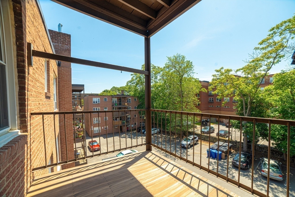 84 Strathmore Road, Unit 7 Boston, MA 02135 - Photo 14 of 17 a view of a balcony with wooden floor
