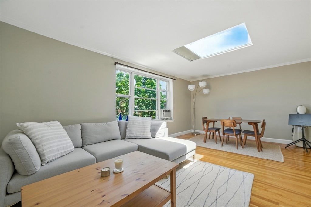84 Strathmore Road, Unit 7 Boston, MA 02135 - Photo 6 of 17 a living room with furniture and a wooden floor