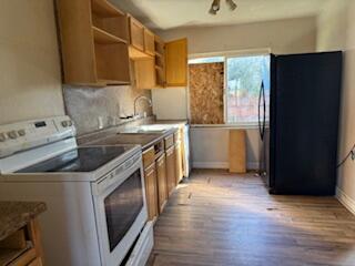 1200 3rd Street Redding, CA 96002 - Photo 13 of 31 a kitchen with a stove sink and a refrigerator