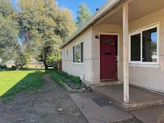 1200 3rd Street Redding, CA 96002 - Photo 21 of 31 a view of a house with backyard and trees