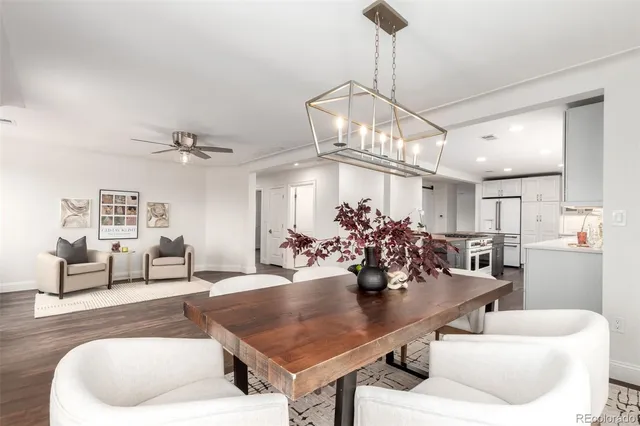 a living room with dining table and wooden floor