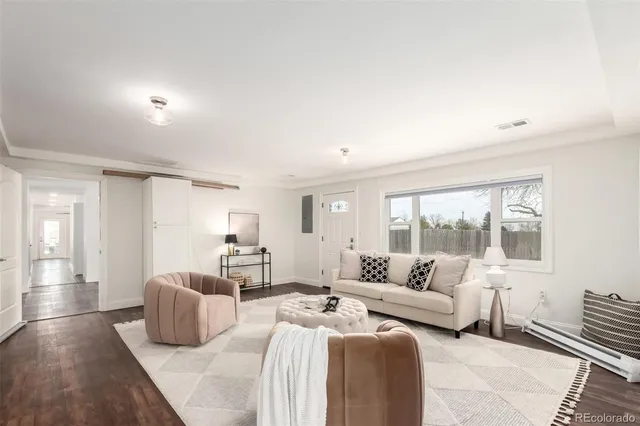 a bedroom with furniture and a large window