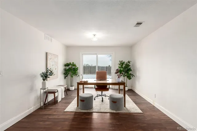 a dining room with furniture window and wooden floor