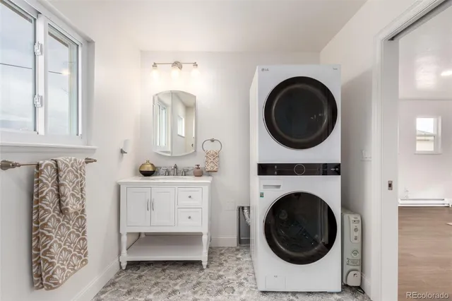 a utility room with sink dryer and washer
