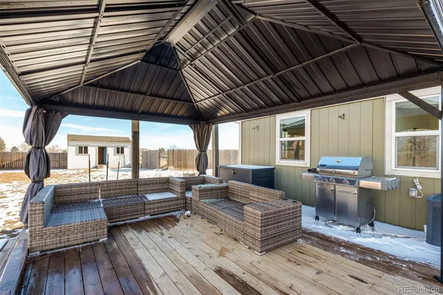 a outdoor living space with patio furniture and wooden floor