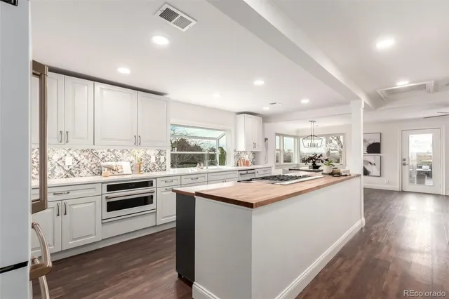 a kitchen with appliances a sink and cabinets