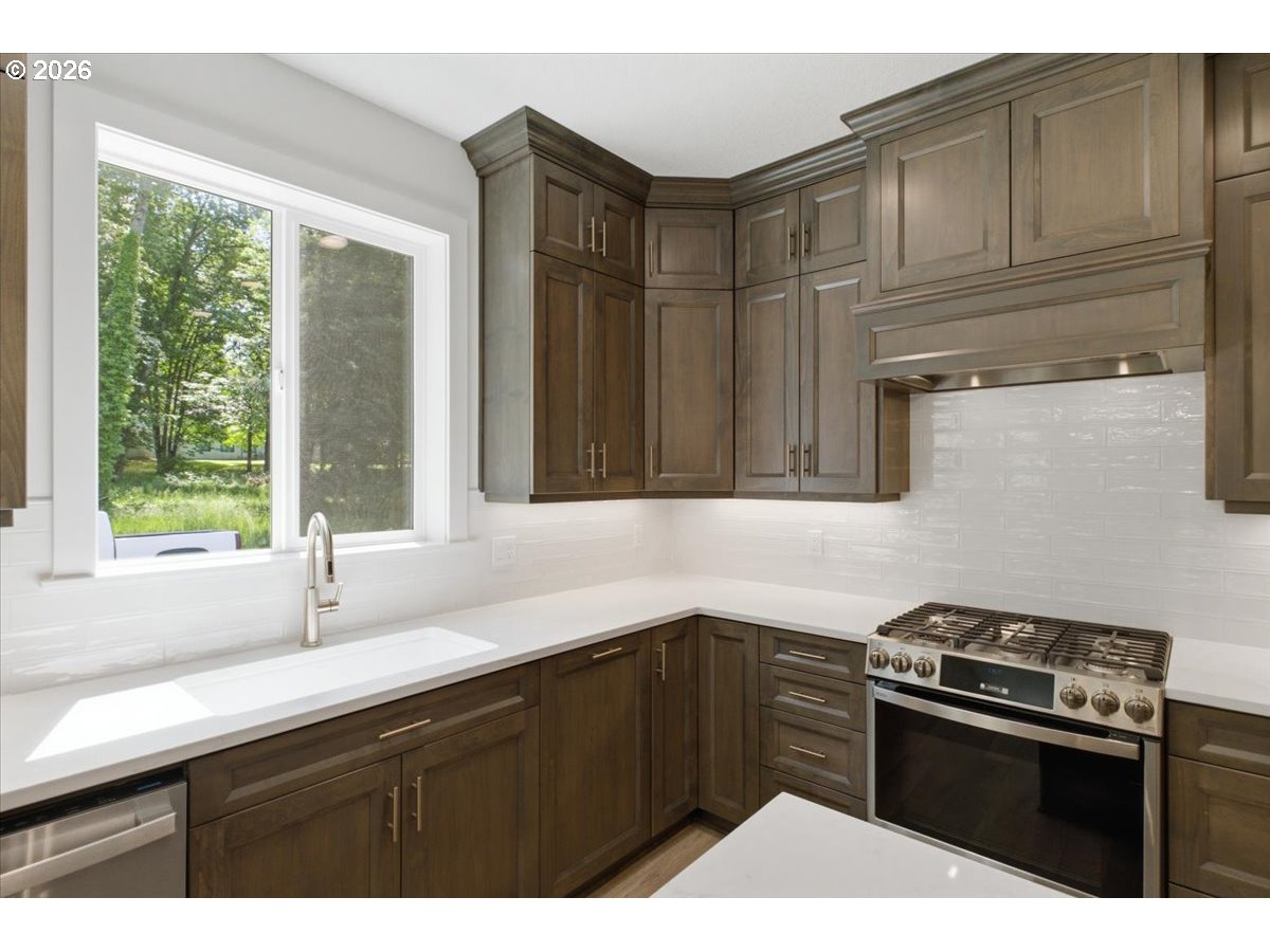 2147 Northeast Spitz Road Canby, OR 97013 - Photo 9 of 48 a kitchen with granite countertop a sink stainless steel appliances wooden floor and cabinets
