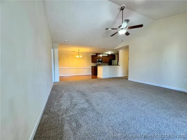 a view of a room with a kitchen