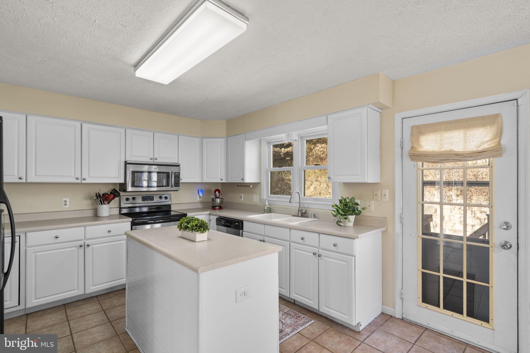 42 Lawhorn Road Stafford, VA 22554 - Photo 11 of 46 a kitchen with cabinets appliances a sink and a window