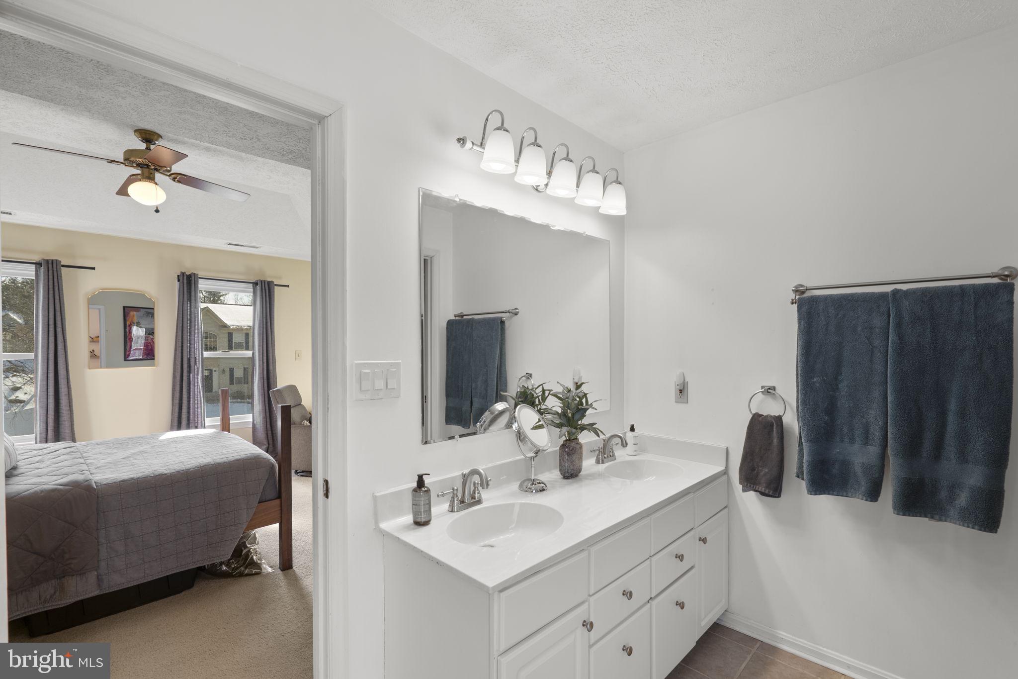 42 Lawhorn Road Stafford, VA 22554 - Photo 28 of 46 a en suite bathroom with a double vanity sink and a mirror