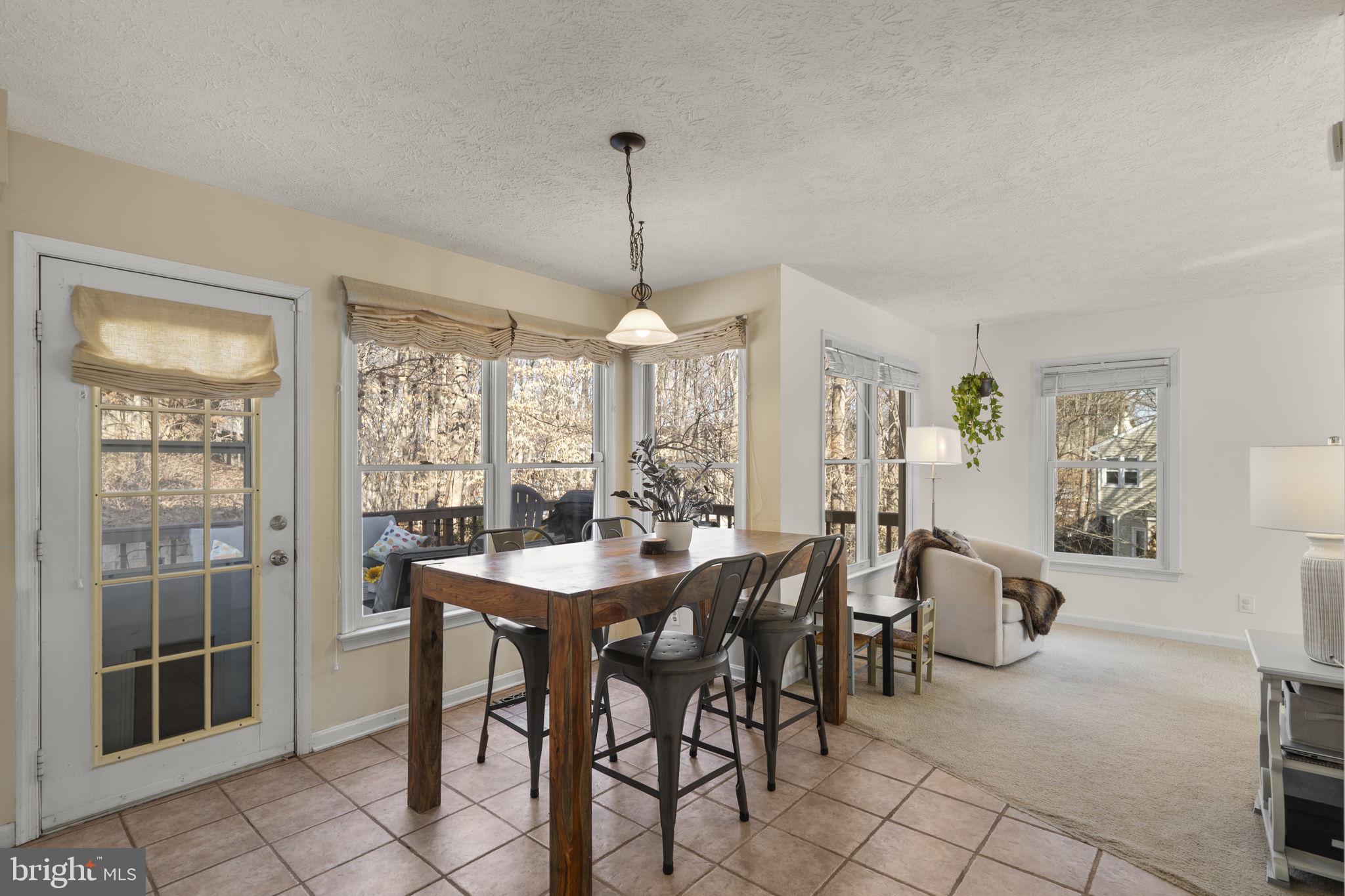 42 Lawhorn Road Stafford, VA 22554 - Photo 10 of 46 a view of a dining room and livingroom with furniture wooden floor a chandelier
