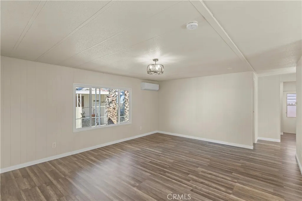 1097 North N State, Unit 194 Hemet, CA 92543 - Photo 11 of 19 an empty room with wooden floor chandelier and windows