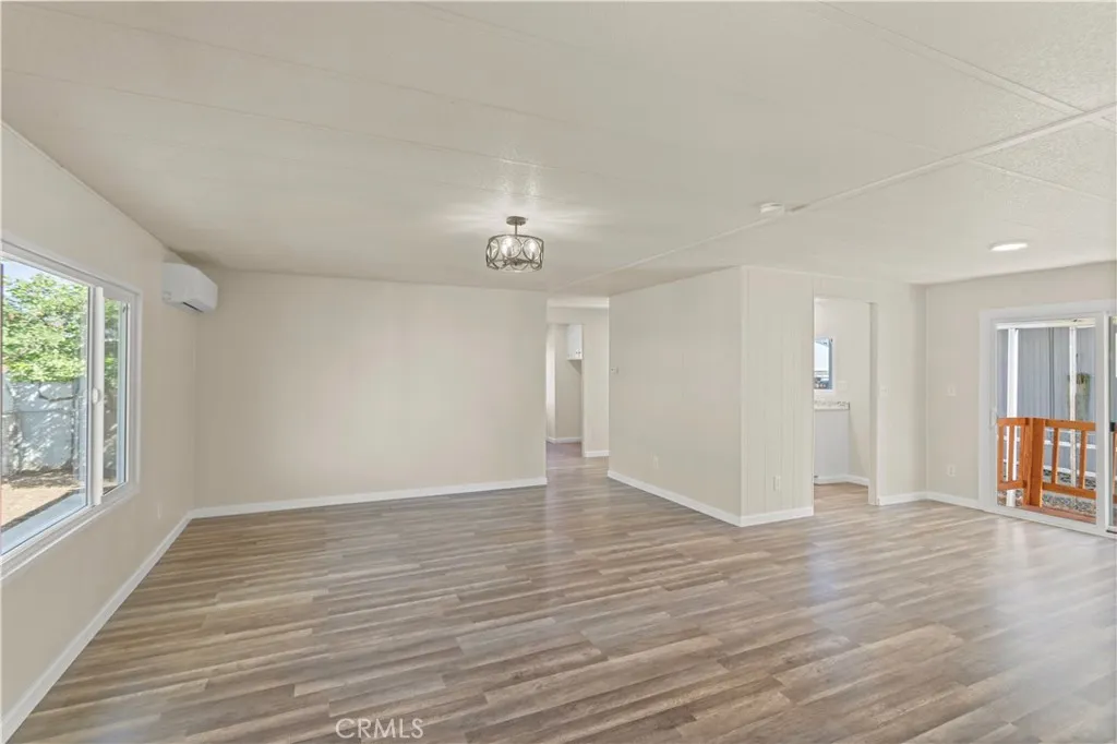 1097 North N State, Unit 194 Hemet, CA 92543 - Photo 12 of 19 a view of an empty room with wooden floor and a window