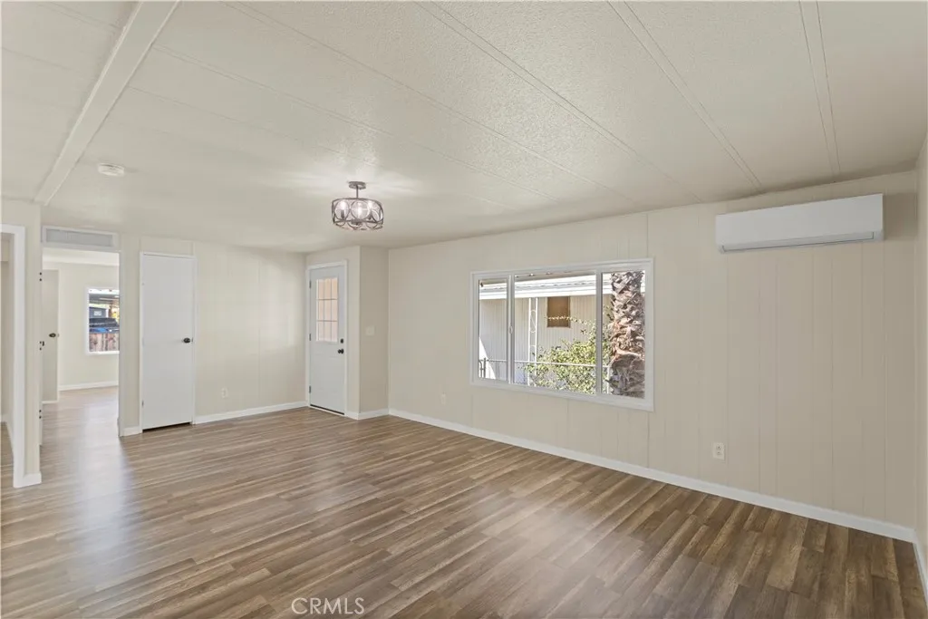 1097 North N State, Unit 194 Hemet, CA 92543 - Photo 10 of 19 wooden floor in an empty room with a window
