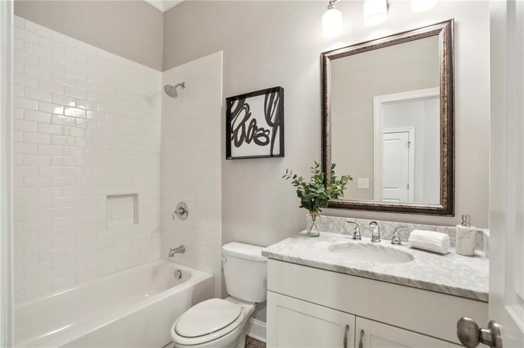 2585 Drew Valley Road Northeast Brookhaven, GA 30319 - Photo 17 of 44 a bathroom with a granite countertop sink toilet and shower