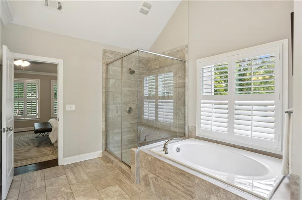 2585 Drew Valley Road Northeast Brookhaven, GA 30319 - Photo 37 of 44 a bathroom with a bathtub and a shower