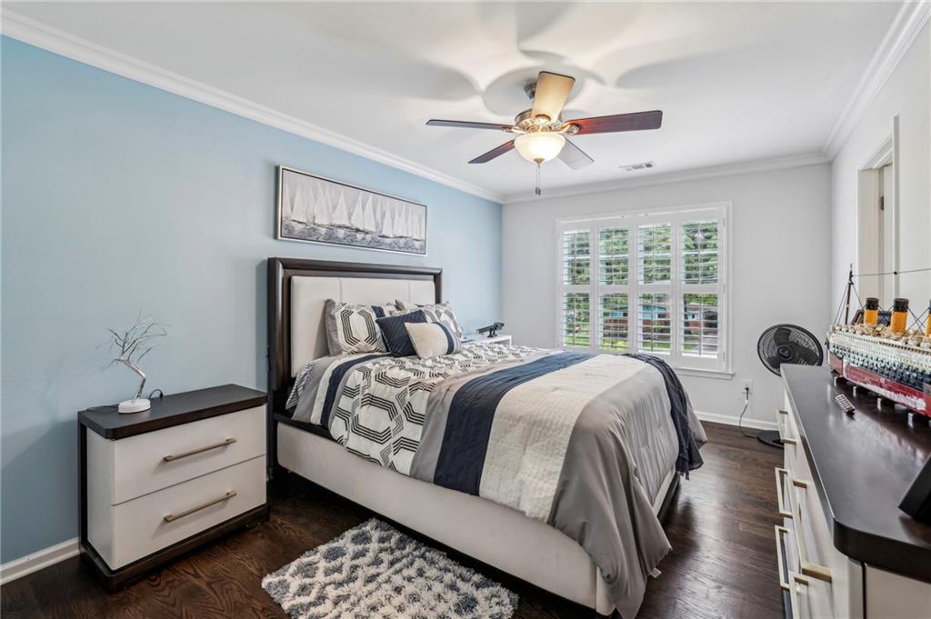 2585 Drew Valley Road Northeast Brookhaven, GA 30319 - Photo 38 of 44 a bedroom with a large bed and a chandelier