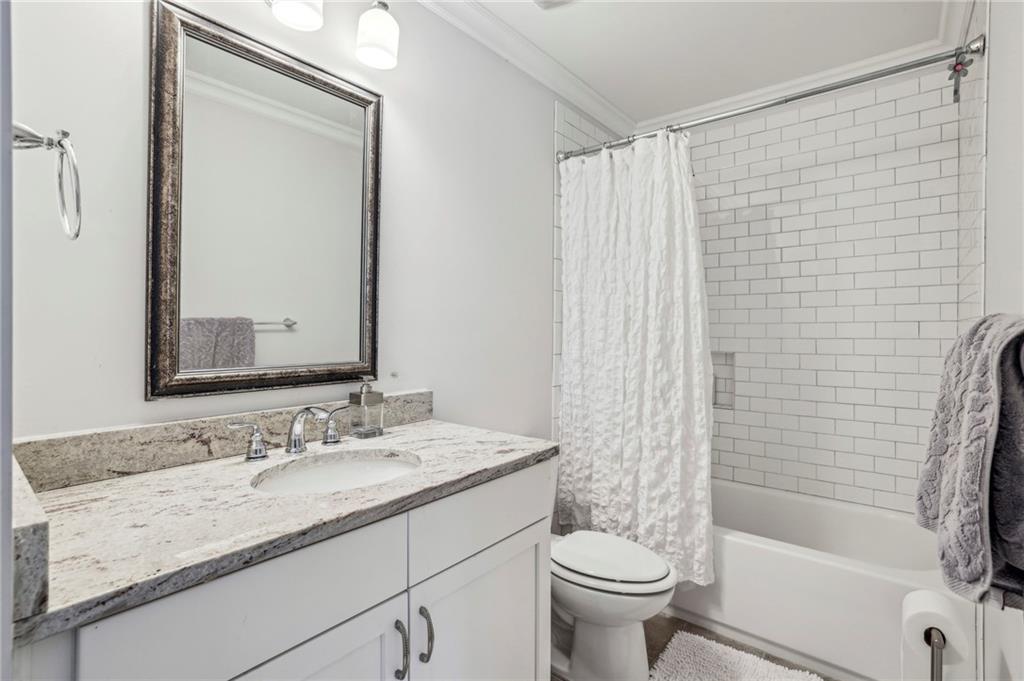 2585 Drew Valley Road Northeast Brookhaven, GA 30319 - Photo 39 of 44 a bathroom with a granite countertop sink toilet and shower