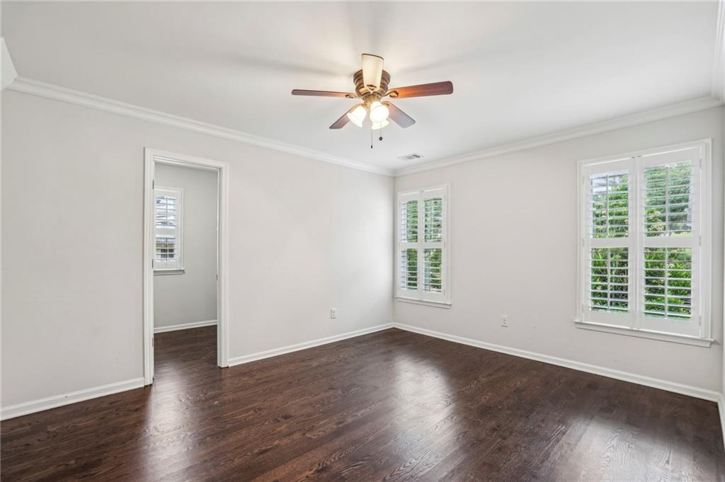 2585 Drew Valley Road Northeast Brookhaven, GA 30319 - Photo 40 of 44 an empty room with wooden floor window and ceiling fan