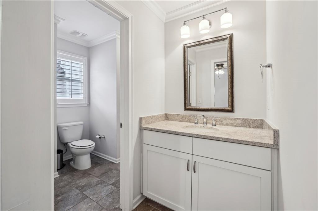 2585 Drew Valley Road Northeast Brookhaven, GA 30319 - Photo 41 of 44 a bathroom with a granite countertop toilet sink and mirror