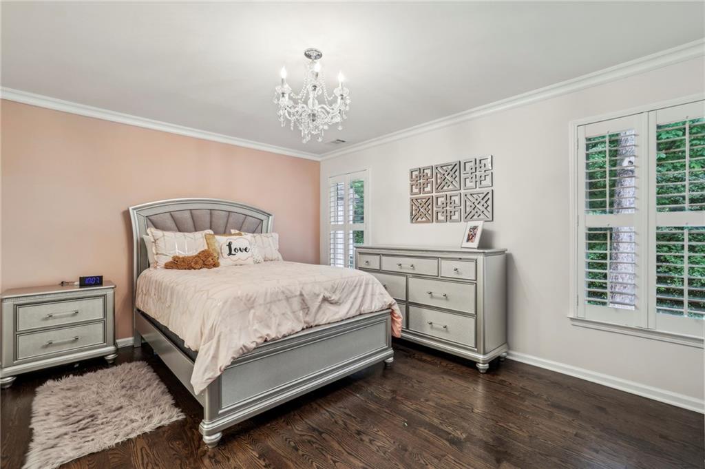 2585 Drew Valley Road Northeast Brookhaven, GA 30319 - Photo 43 of 44 a bedroom with a bed and a chandelier