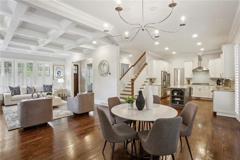 2585 Drew Valley Road Northeast Brookhaven, GA 30319 - Photo 6 of 44 a dining room with furniture a kitchen and chandelier