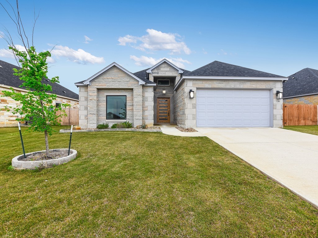 a front view of a house with a yard