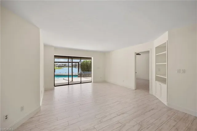 a large kitchen with granite countertop a stove sink and cabinets