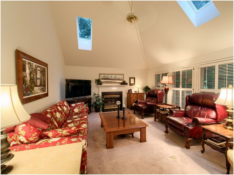 8501 Bluebill Court Raleigh, NC 27615 - Photo 12 of 25 Cozy family room has fireplace with gas logs and ceiling fan. Family room