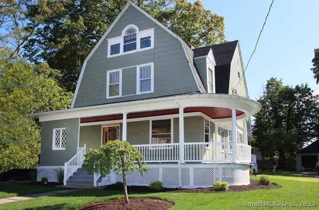 a front view of a house with a yard and porch