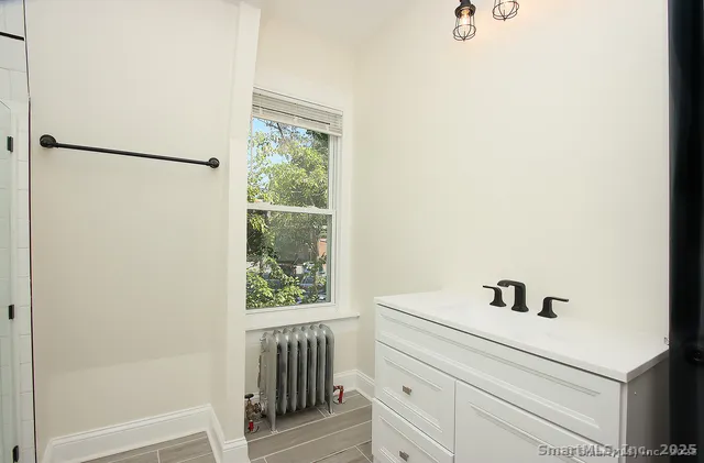 a bathroom with a sink and a window