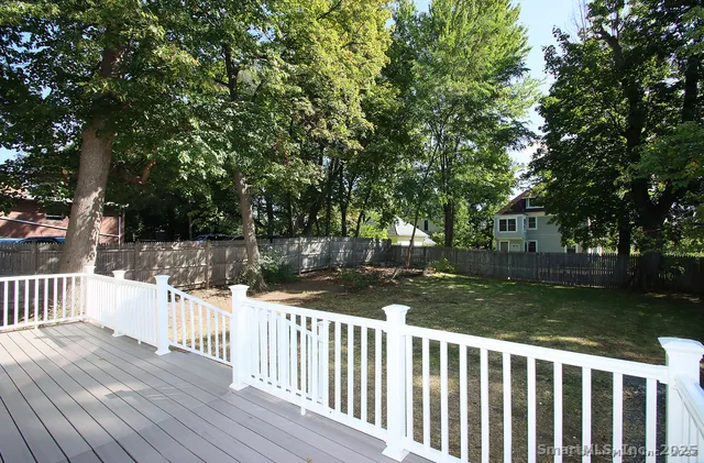 a view of a yard with wooden fence