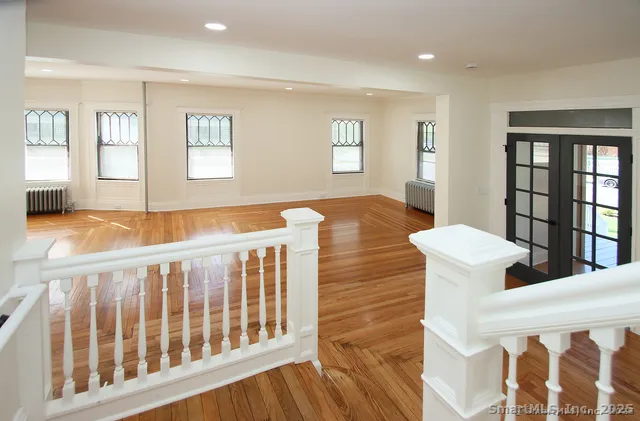 a bedroom with furniture and wooden floor