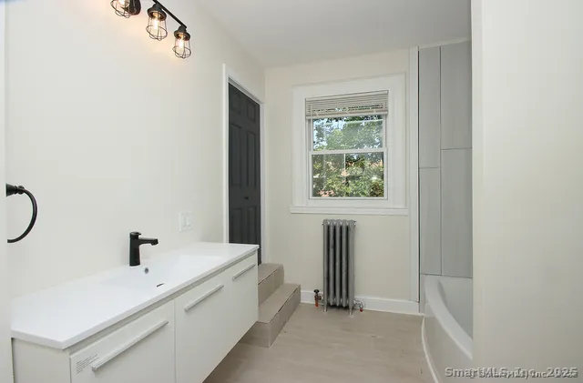 a bathroom with a bathtub and shower