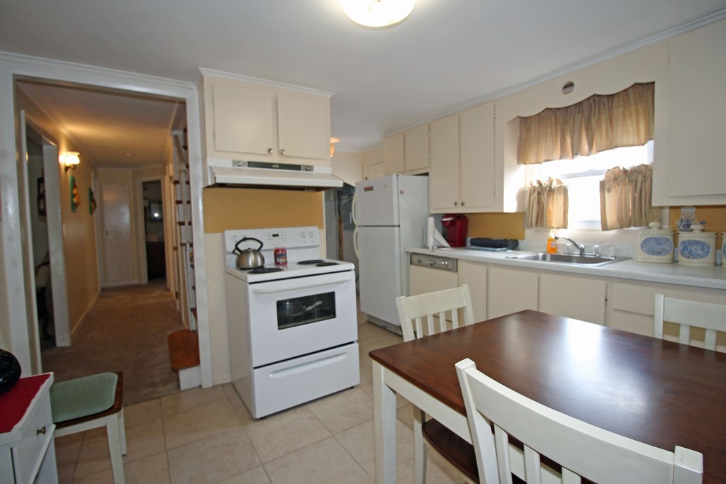 430 Newport Road Hull, MA 02045 - Photo 4 of 10 a kitchen with a stove a sink and a refrigerator