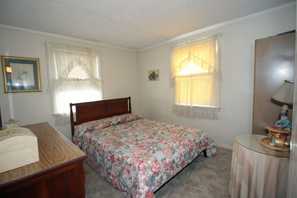 430 Newport Road Hull, MA 02045 - Photo 7 of 10 a bedroom with a bed and window
