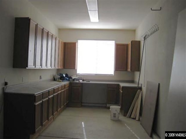 4542 Goodwin Road Sparks, NV 89436 - Photo 9 of 9 a kitchen with stainless steel appliances granite countertop a refrigerator and a sink
