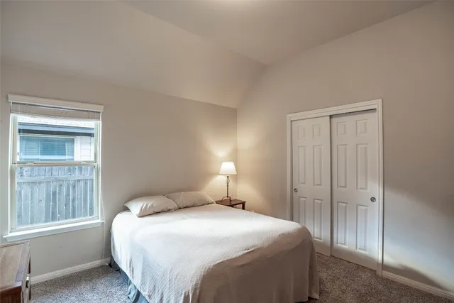 a bedroom with a bed and closet