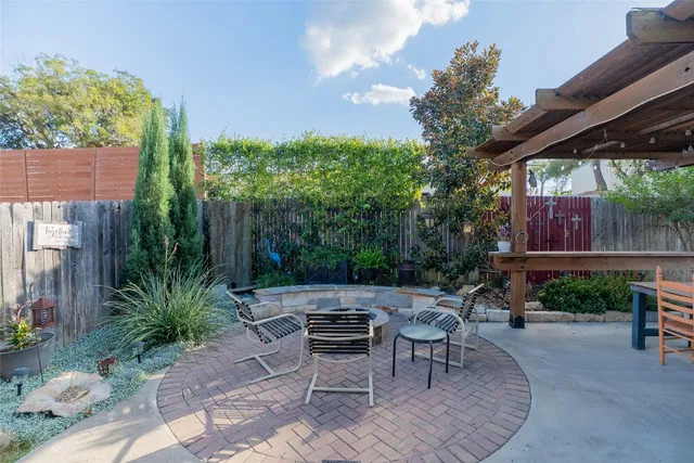 a building outdoor space with patio furniture and potted plants
