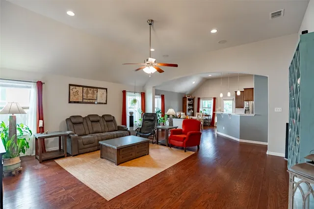 a living room with furniture and a chandelier