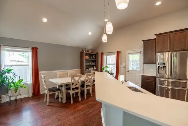 a large kitchen with a table and chairs