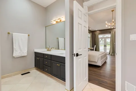 a en suite bathroom with a sink and mirror