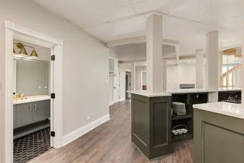 a kitchen with granite countertop a refrigerator and a stove top oven