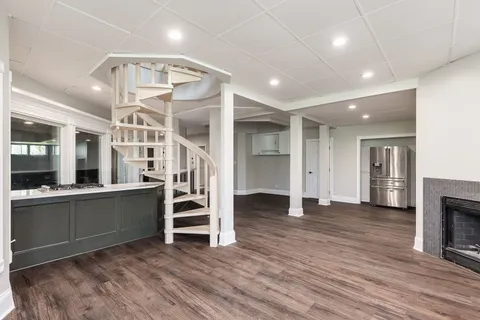 a view of a room with wooden floor and stairs
