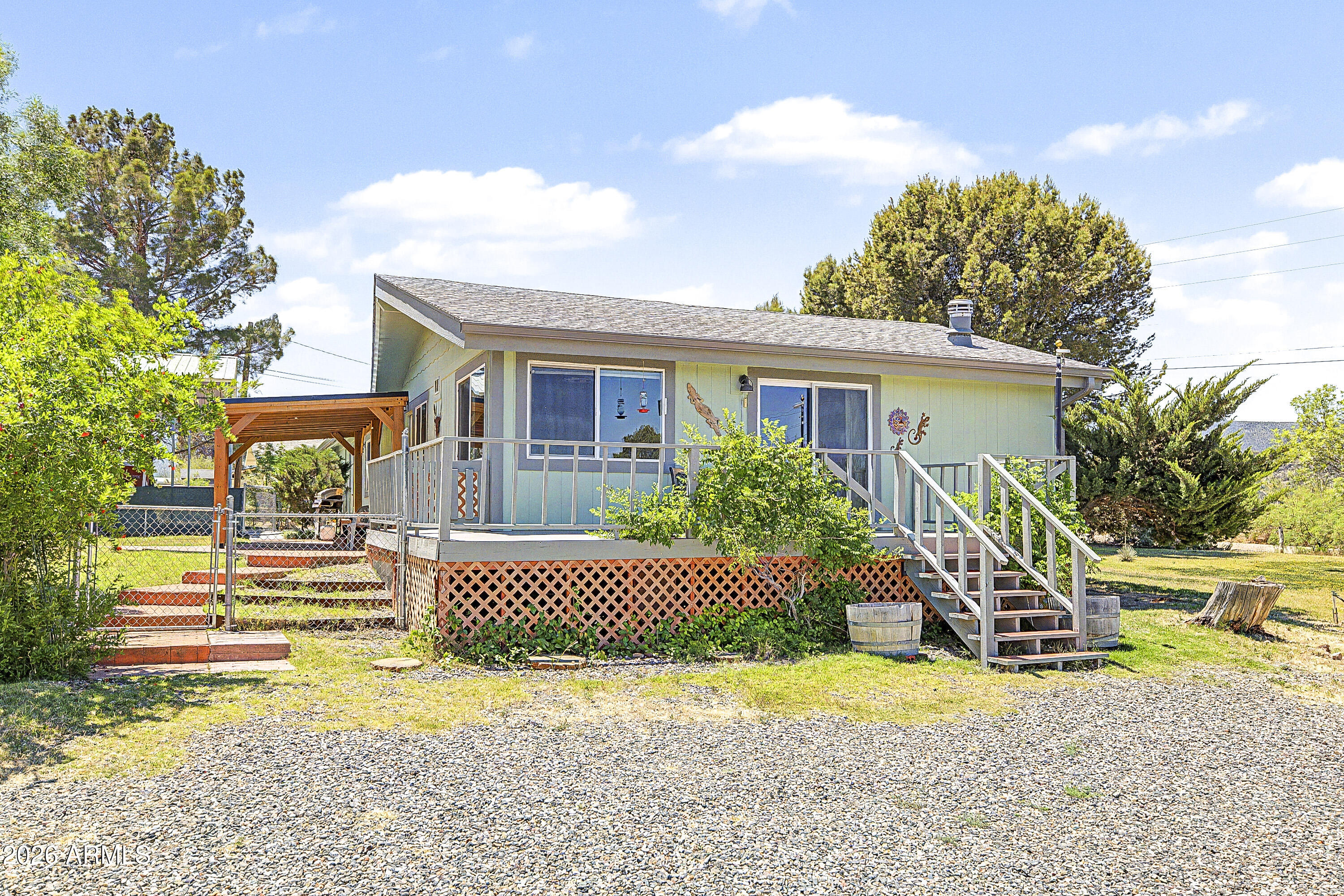 633 Oasis Road Camp Verde, AZ 86322 - Photo 2 of 50 a front view of a house with a yard and potted plants